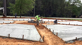 Workers finishing the concrete for the Flag Plaza
